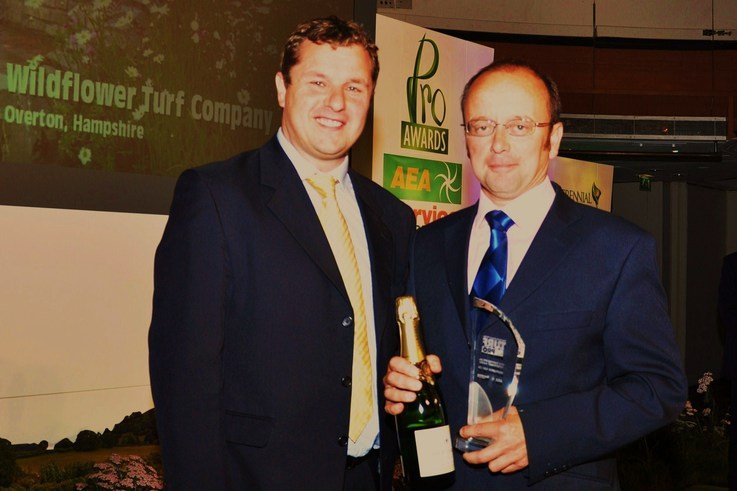 James Hewetson Brown of the Wildflower Turf Company (right) collects the Turf Pro Special Achievement Award from Rupert Price of Ransomes Jacobsen. Pic    Turf Pro