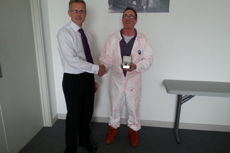 Kevin receiving his award from COO Peter Wood