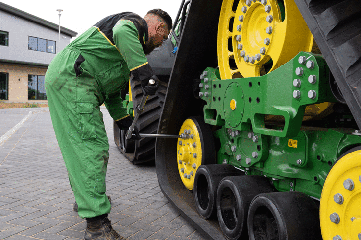 Working-on-a-tracked-John-Deere-tractor.gif