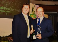 James Hewetson Brown of the Wildflower Turf Company (right) collects the Turf Pro Special Achievement Award from Rupert Price of Ransomes Jacobsen. Pic    Turf Pro