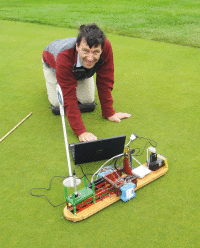 Tim testing prototype on a golf green