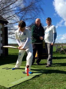 Wetherby CC's 11 year old Jack Dyson tries out the new coaching mat with Cricket Coaching Mat's David Cooper (L) and club chairman Arthur Probert (R) looking on